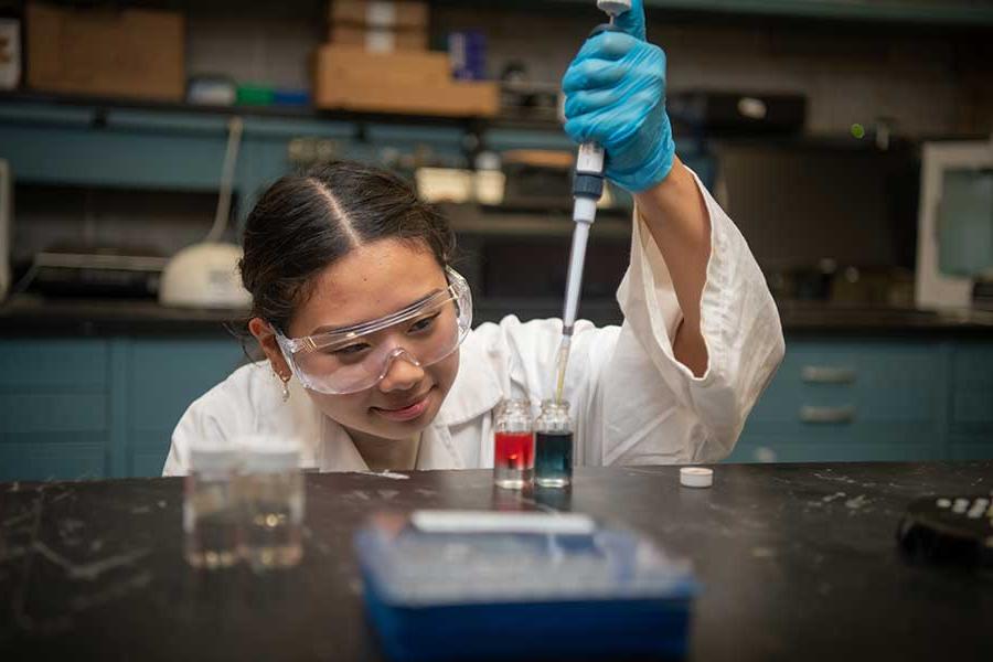 Student conducting experiment in lab.